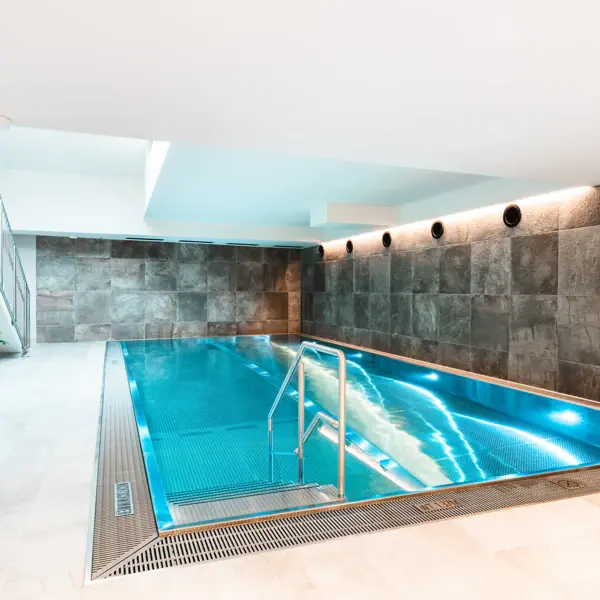 An indoor swimming pool in one room.