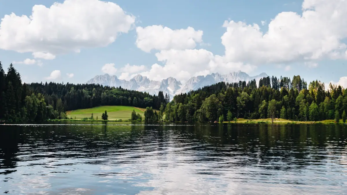 Kitzbühel Schwarzsee Schwarzsee, with trees and mountains in the background.
