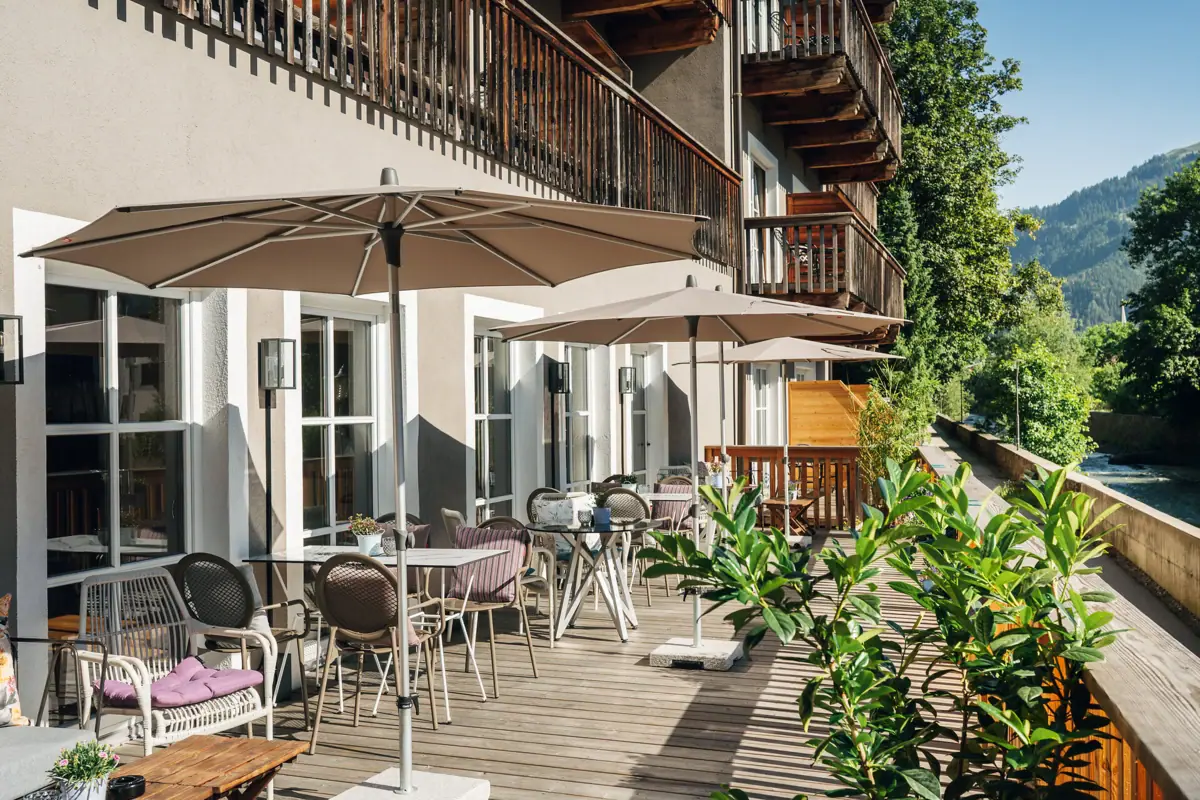 A terrace with chairs and parasols on a deck.