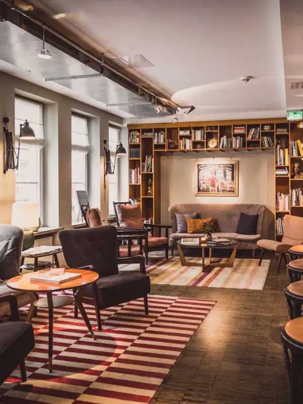 Seating groups consisting of armchairs, tables and a sofa in the lounge area.