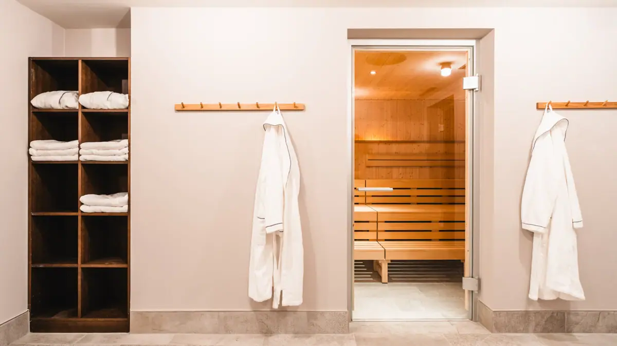 A room with a sauna and a towel rail.