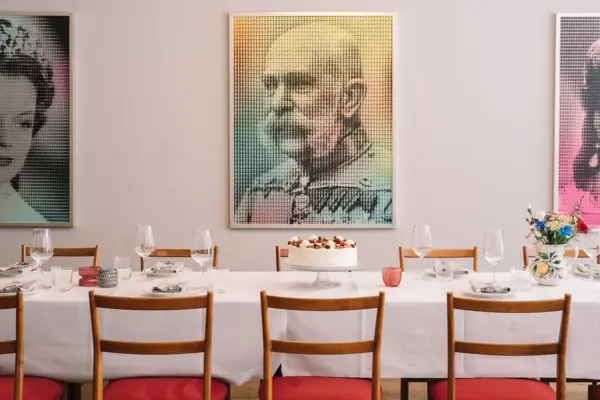 A table with a cake and glasses on it.