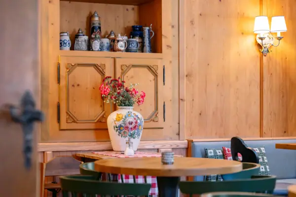 A table with a vase full of flowers on it.