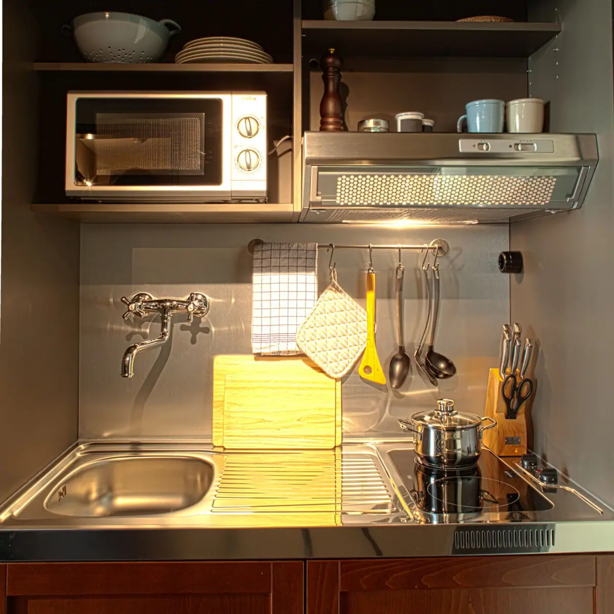 Small kitchen island with sink, two hobs and microwave