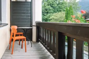 A table and chairs on a deck.
