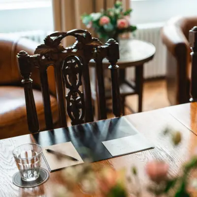 Wooden table with chairs and meeting documents
