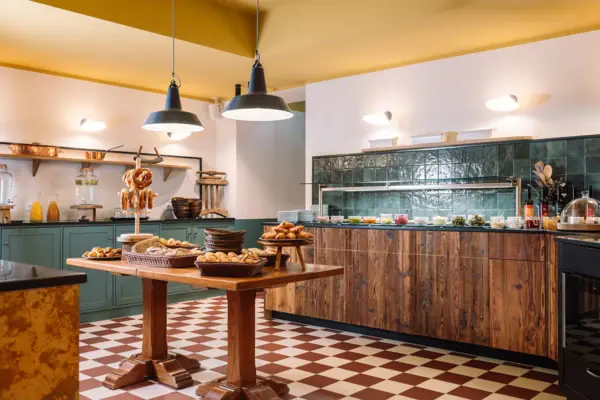 Kitchen with food on a table, featuring cabinetry and a countertop in an indoor setting.