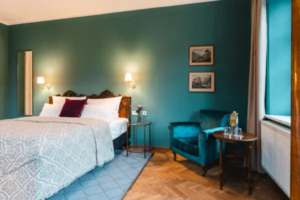 A bedroom with a bed and a chair.