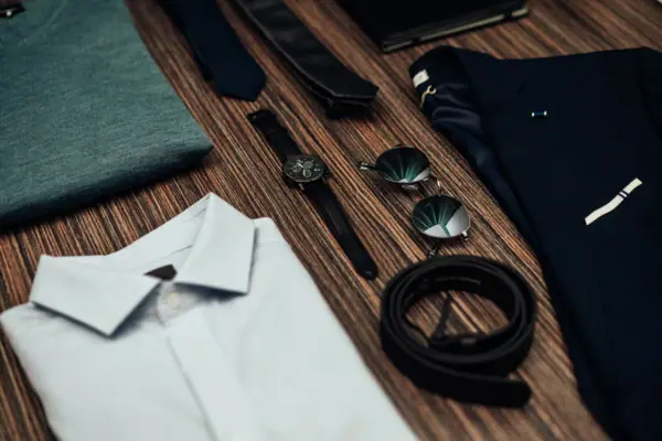 A close-up of a shirt and a pair of sunglasses.