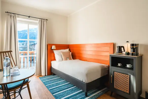 A bed in a room with bedside table and pillows.