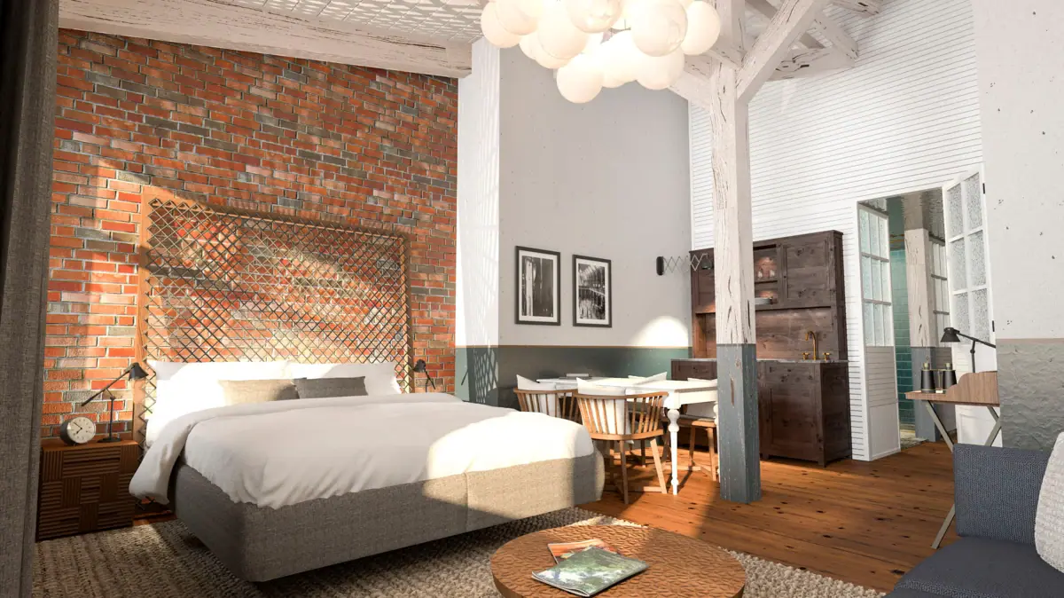 Interior view of a hotel room at the HENRI Hotel Cuxhaven with a bed, table and chairs.
