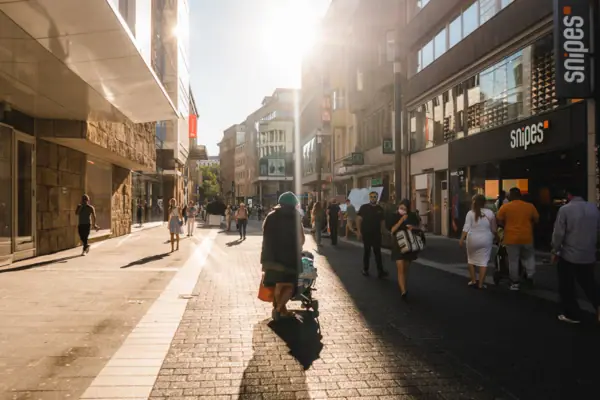 A group of people are walking down a street.