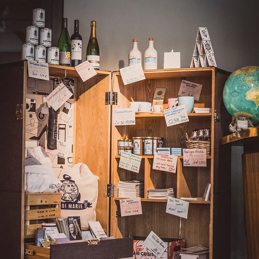 A cupboard with a shelf full of objects.