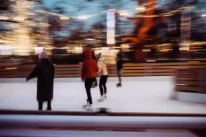 A group of people ice-skating on an ice rink.