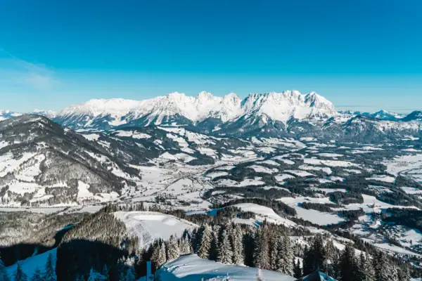 Snow-capped mountains and a valley in a wintry landscape.