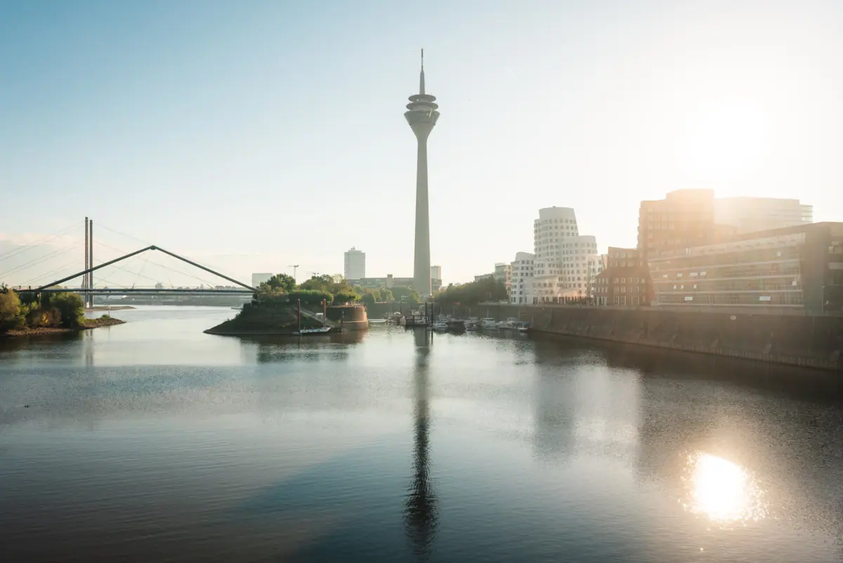 A body of water with a large tower in the background.