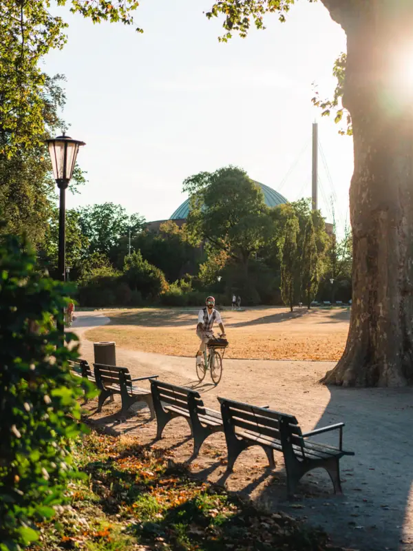 A person is cycling in a park.