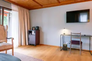 A room with a television and a table.