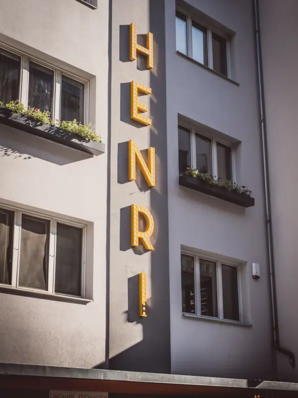 The façade of the HENRI Hotel Vienna A building with a sign on the side.