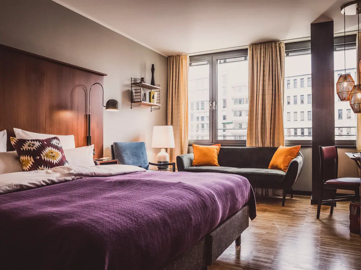 Bedroom with purple bed and couch.