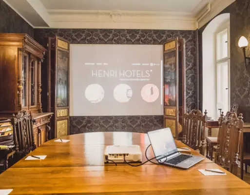 A meeting room with a table and a projector.