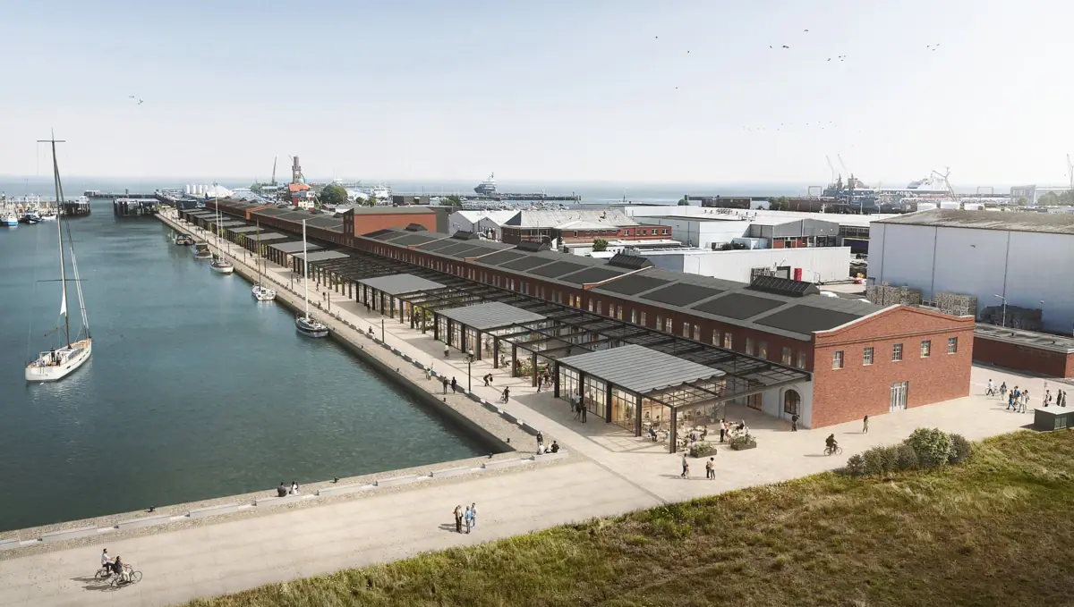 A dock with a building and a body of water.