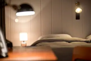 Lamp next to a bed in the interior.