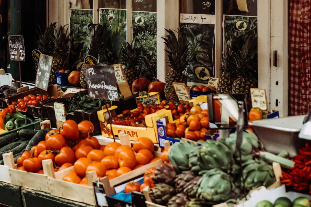 A shop front displaying fruit and vegetables.