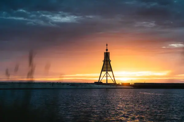 The Kugelbake in Cuxhaven in the Wadden Sea at dusk.