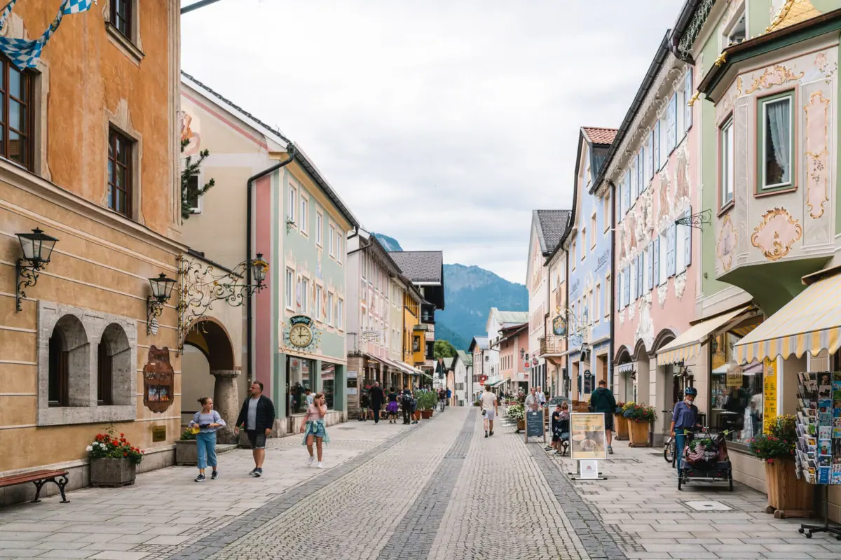 A street with buildings and people out for a walk.